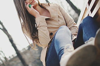 Woman in Trench Coat Talking on Smartphone Outdoors