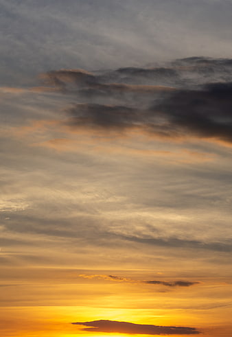 Dramatic sunset sky with golden clouds and gradient light