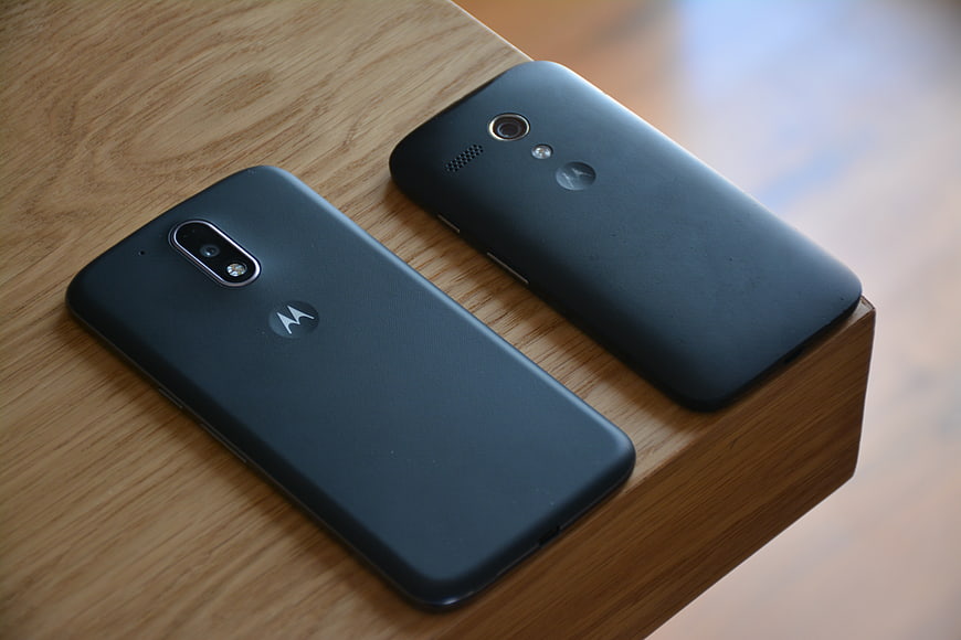 Two Black Motorola Smartphones on Wooden Surface