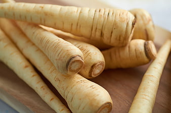 Fresh parsnips on wooden cutting board