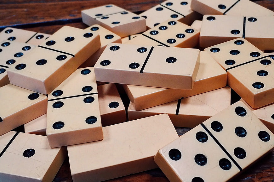 Scattered Vintage Domino Tiles on Wooden Table