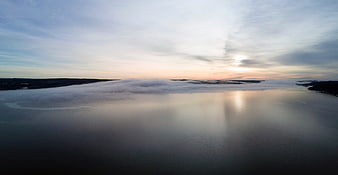 Aerial View of Misty Lake at Sunrise with Clouds