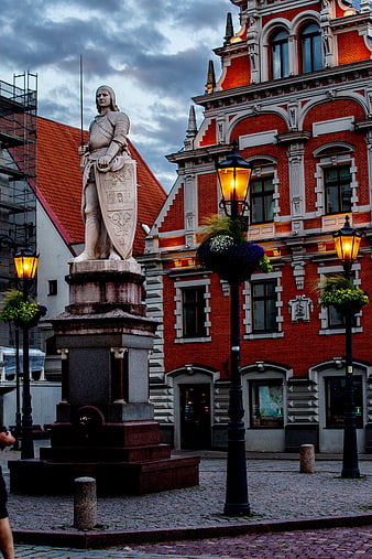 Historic Knight Statue and Red Brick Architecture in Riga Town Hall Square