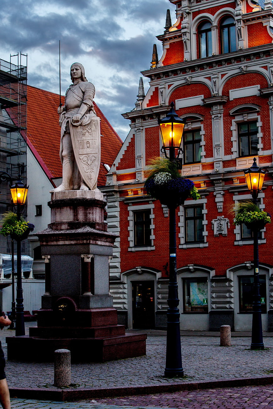 Historic Knight Statue and Red Brick Architecture in Riga Town Hall Square