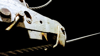 Close-up of industrial steel cable clamp on black background