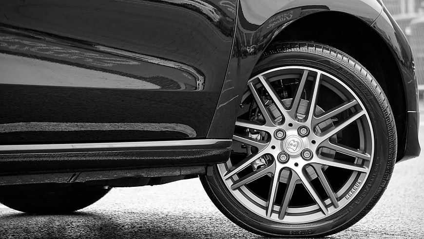 Close-up of luxury car wheel and tire in black and white