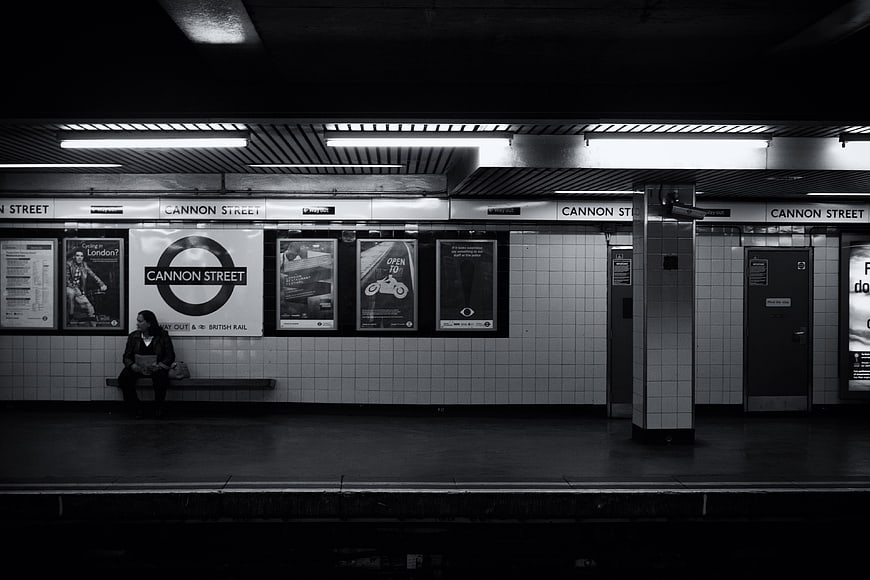 Lonely Woman Sitting Alone on Cannon Street London Underground Platform