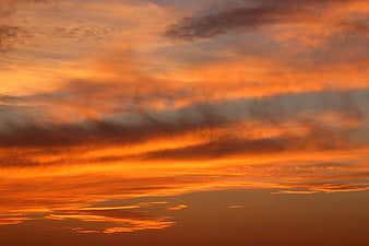 Vibrant Orange Sunset Sky with Dramatic Clouds