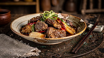Braised Beef with Vegetables in Rustic Ceramic Bowl