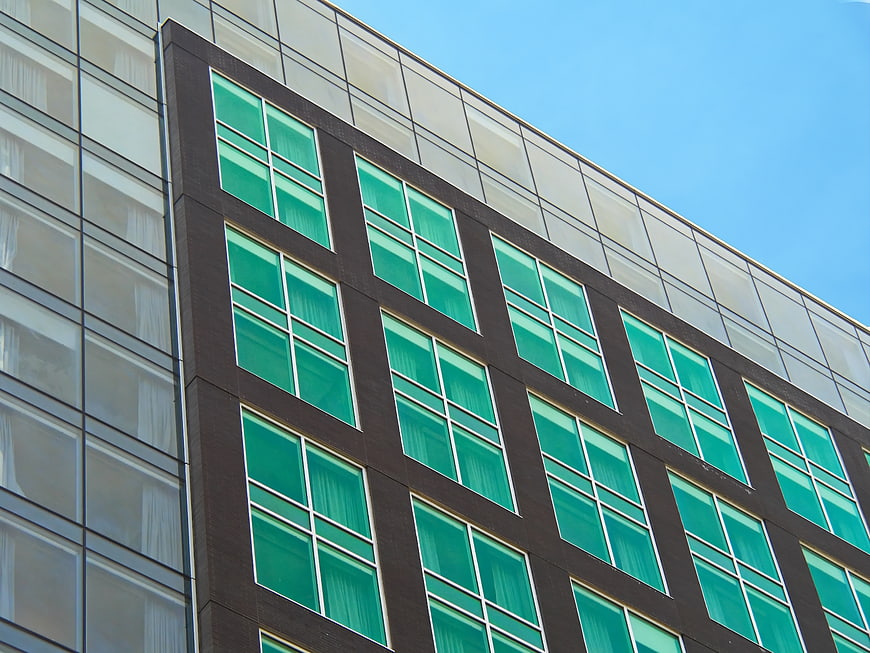 Modern Office Building Facade with Green Glass Windows