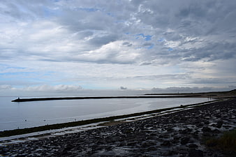 Dramatic Seascape with Rocky Shore and Cloudy Sky