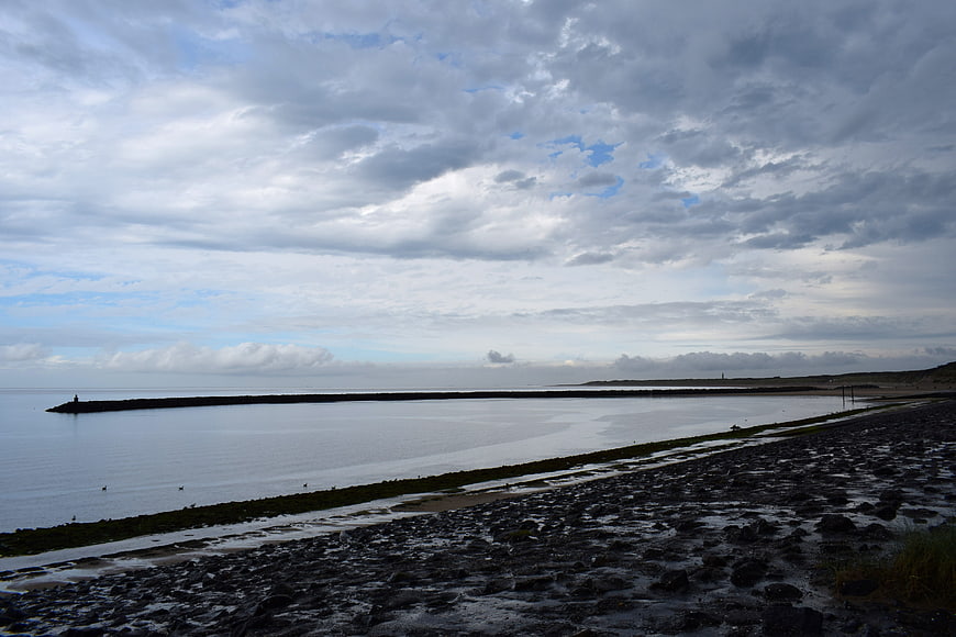 Dramatic Seascape with Rocky Shore and Cloudy Sky