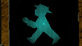 Close-up of illuminated green pedestrian traffic light signal