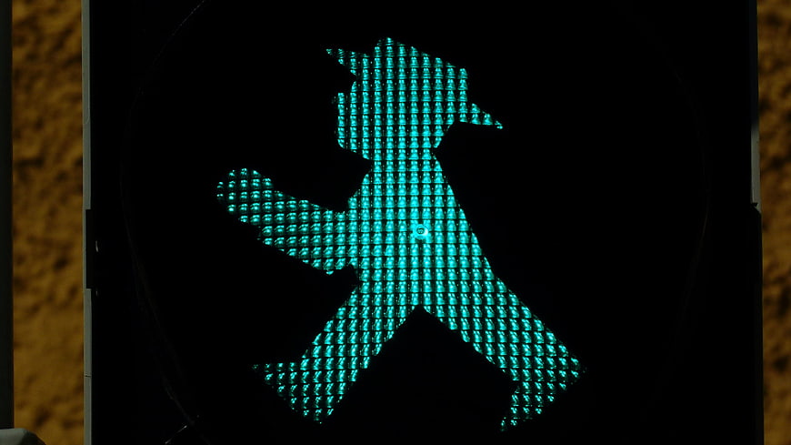 Close-up of illuminated green pedestrian traffic light signal