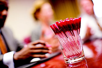 Red Pens In Glass Cup During Corporate Business Meeting