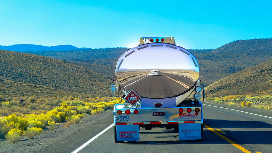 Shiny tanker truck driving on desert highway