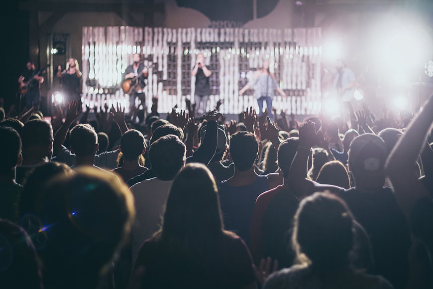 Live Concert Crowd with Band Performing on Stage