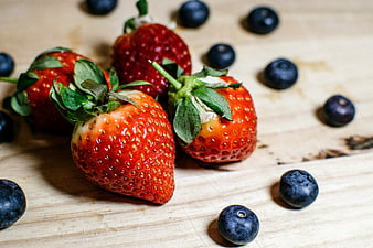 Fresh Strawberries and Blueberries on Wooden Surface