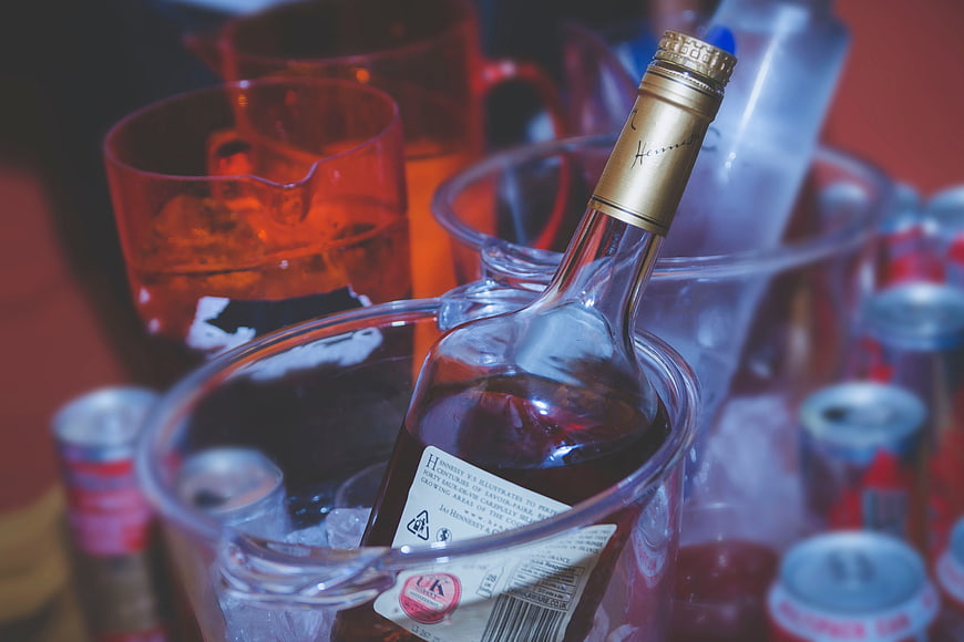 Hennessy Cognac Bottle in Ice Bucket with Party Drinks