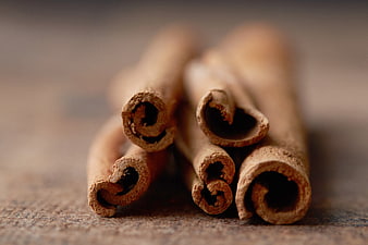 Close-up of cinnamon sticks on rustic wooden surface