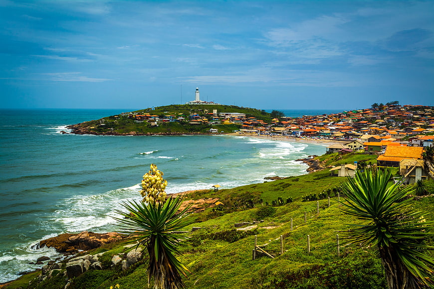 Coastal landscape with lighthouse and colorful houses