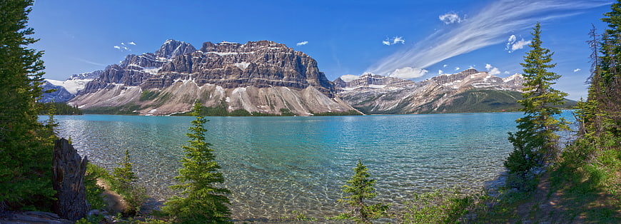 Panoramic View of Turquoise Mountain Lake with Snow-Capped Peaks