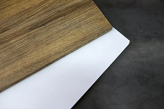 Laminated wood board and white panel on dark background