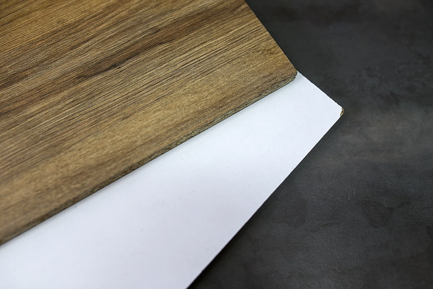 Laminated wood board and white panel on dark background