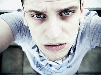 High-Angle Close-Up Portrait of Young Man With Intense Blue Eyes