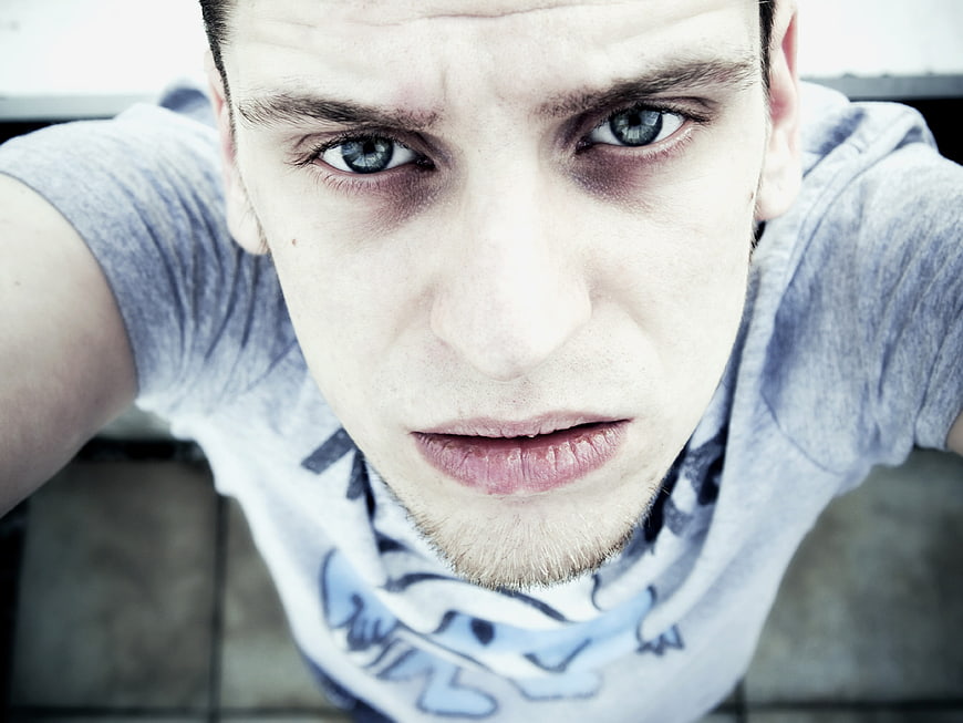High-Angle Close-Up Portrait of Young Man With Intense Blue Eyes