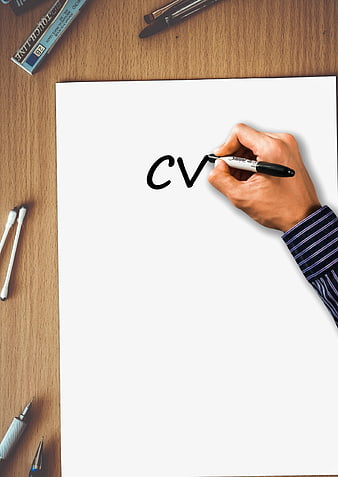 Hand writing CV on white paper with office supplies