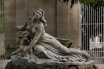 Weathered Marble Statue of Reclining Woman in Park