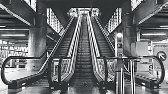Symmetrical Black and White Escalator in Modern Transit Station