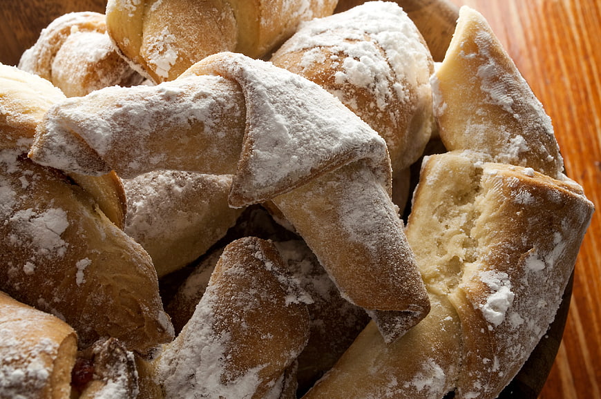 Close-up of powdered sugar dusted fried dough pastries
