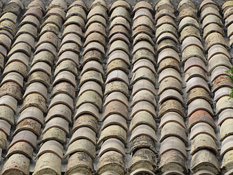 Close-up of weathered terracotta roof tiles pattern