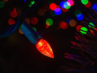 Close-up of Red Christmas Light Bulb with Bokeh Background