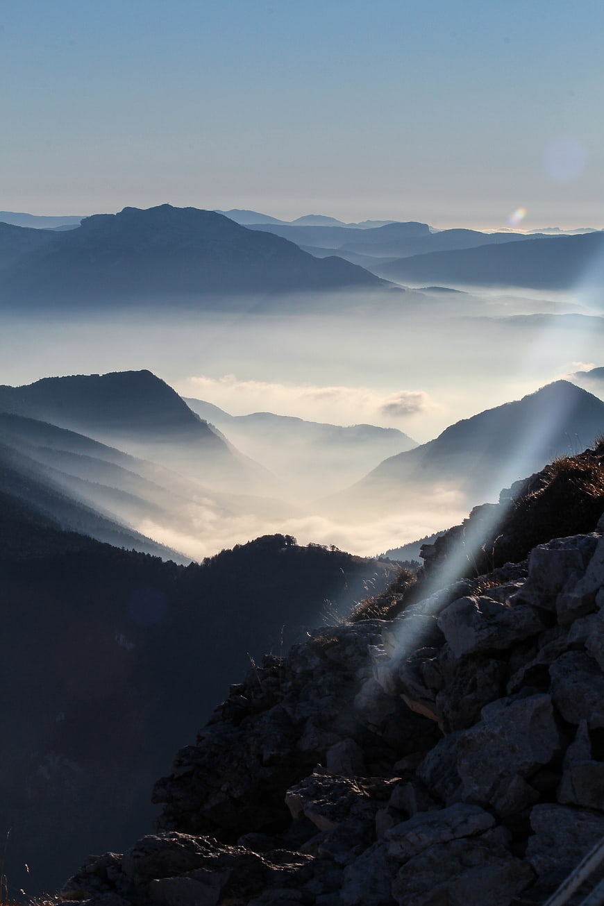 Misty Mountain Landscape with Sunbeams and Foggy Valleys