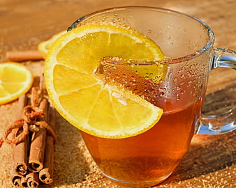 Hot Tea with Lemon and Cinnamon on Wooden Table
