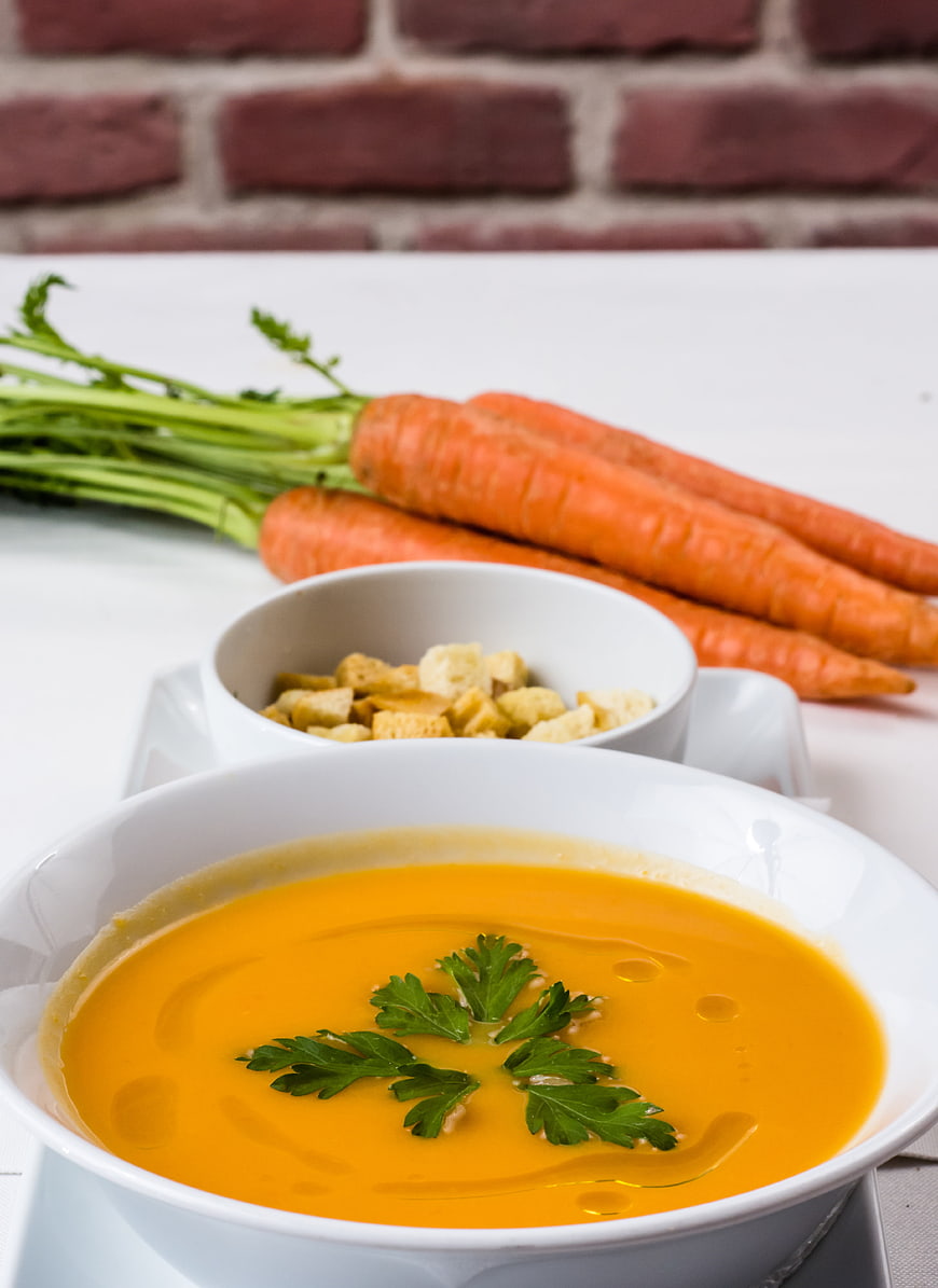Creamy Carrot Soup with Croutons and Fresh Parsley Garnish