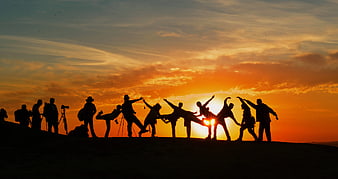 Silhouette of Hikers Celebrating at Sunset