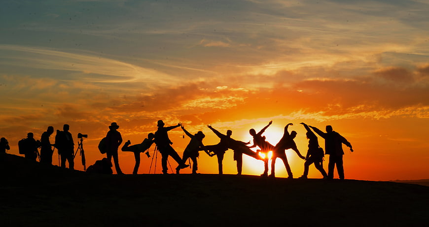 Silhouette of Hikers Celebrating at Sunset