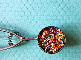 Colorful Sprinkles In Metal Scoop On Blue Textured Background