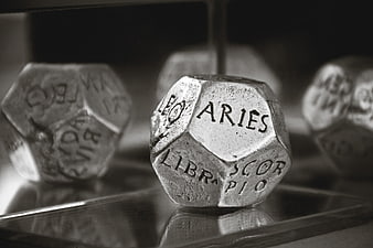 Close-up of Zodiac Sign Dice with Aries in Focus