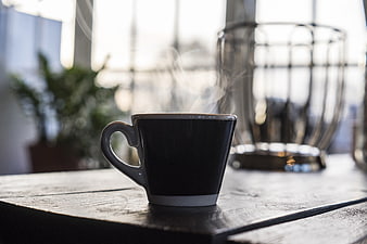 Steaming Black Coffee Cup on Rustic Wooden Table