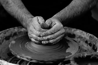 Close-up of hands shaping clay on a pottery wheel