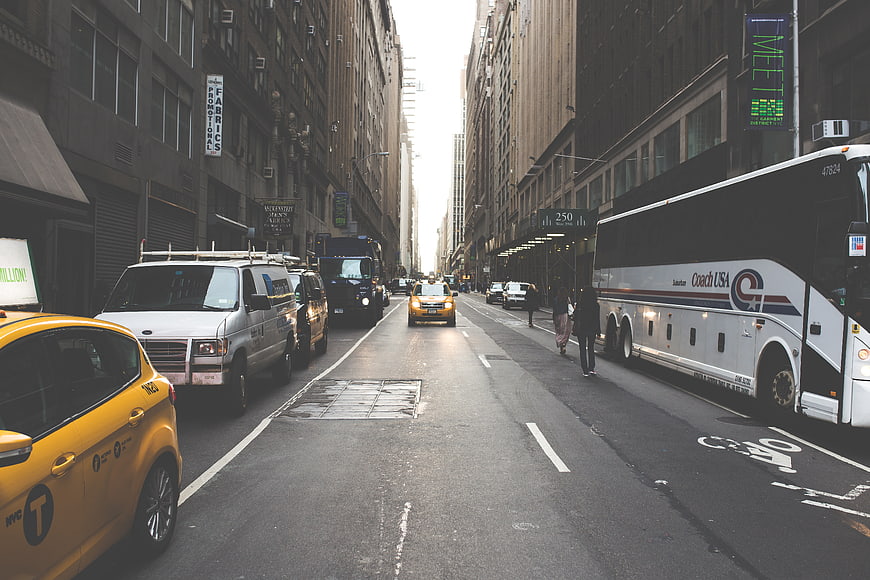 Busy New York City Street with Yellow Taxi and Tour Bus