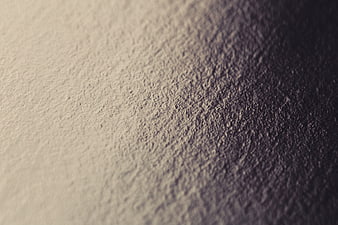 Close-up textured wall surface with diagonal shadow gradient