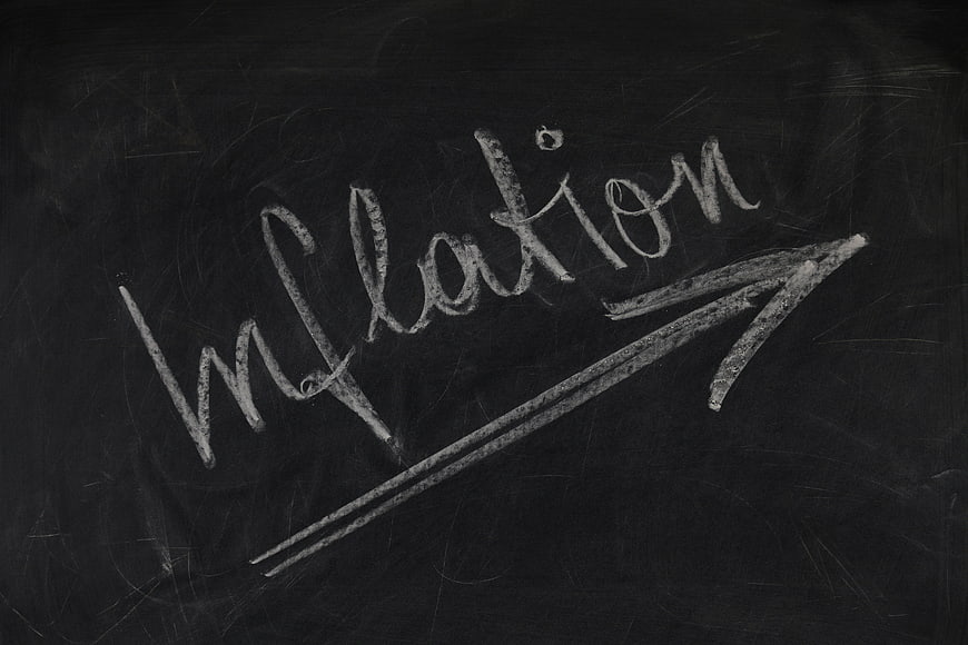 Inflation written on blackboard with upward arrow