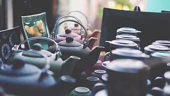 Collection of ceramic teapots and tea accessories on a table