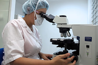 Female scientist using microscope in laboratory
